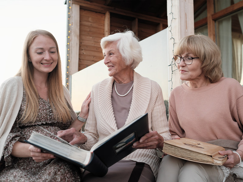 grandmother looking at photo album with her daughter and granddaughter what is an annuity orlando fl