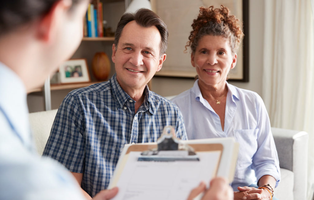 senior couple meeting with financial advisor discussing the benefits of a fixed indexed annuity orlando fl